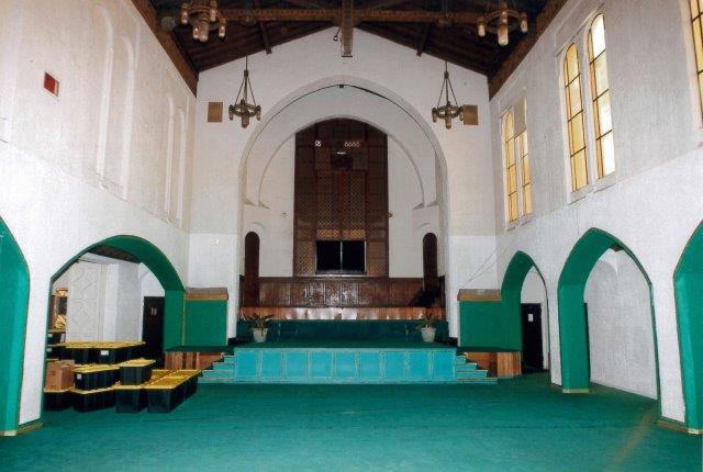 Before: Interior view of sanctuary and altar. Architectural features are contrasted using green paint, which matches the green carpet.